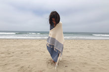 Load image into Gallery viewer, Person wrapped in a blanket on a beach with ocean in the background
